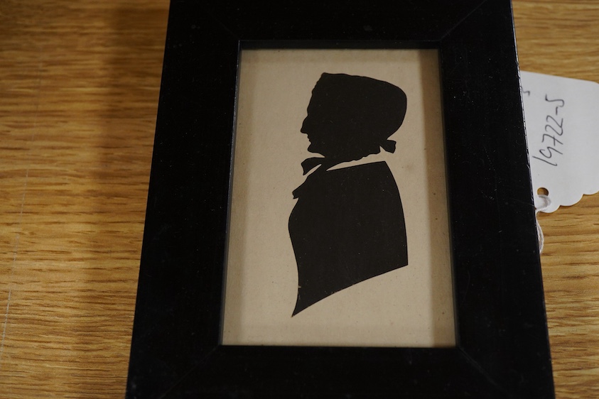Two early 19th century cut-paper silhouette portraits of ladies, together with a stipple engraving, Portrait of a semi-nude woman, largest 10 x 8.5cm, each housed in ebonised frames